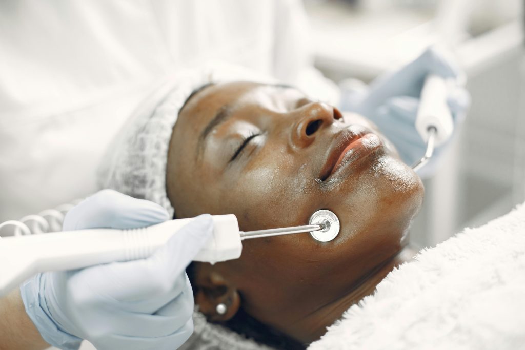 Close-up of a woman receiving a facial skincare treatment in a spa.